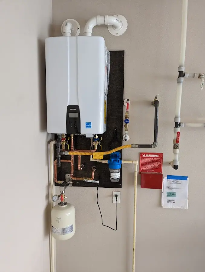 Professional plumber installing copper piping in a Bee Cave home